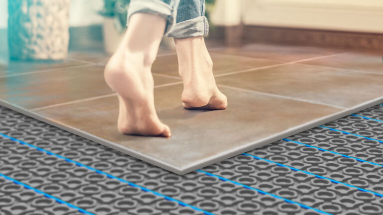 When I step out of the shower, what makes the tile floor so much colder  than the bathroom mat?