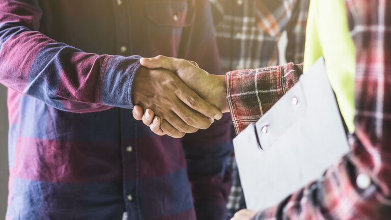 Two contractors shaking hands